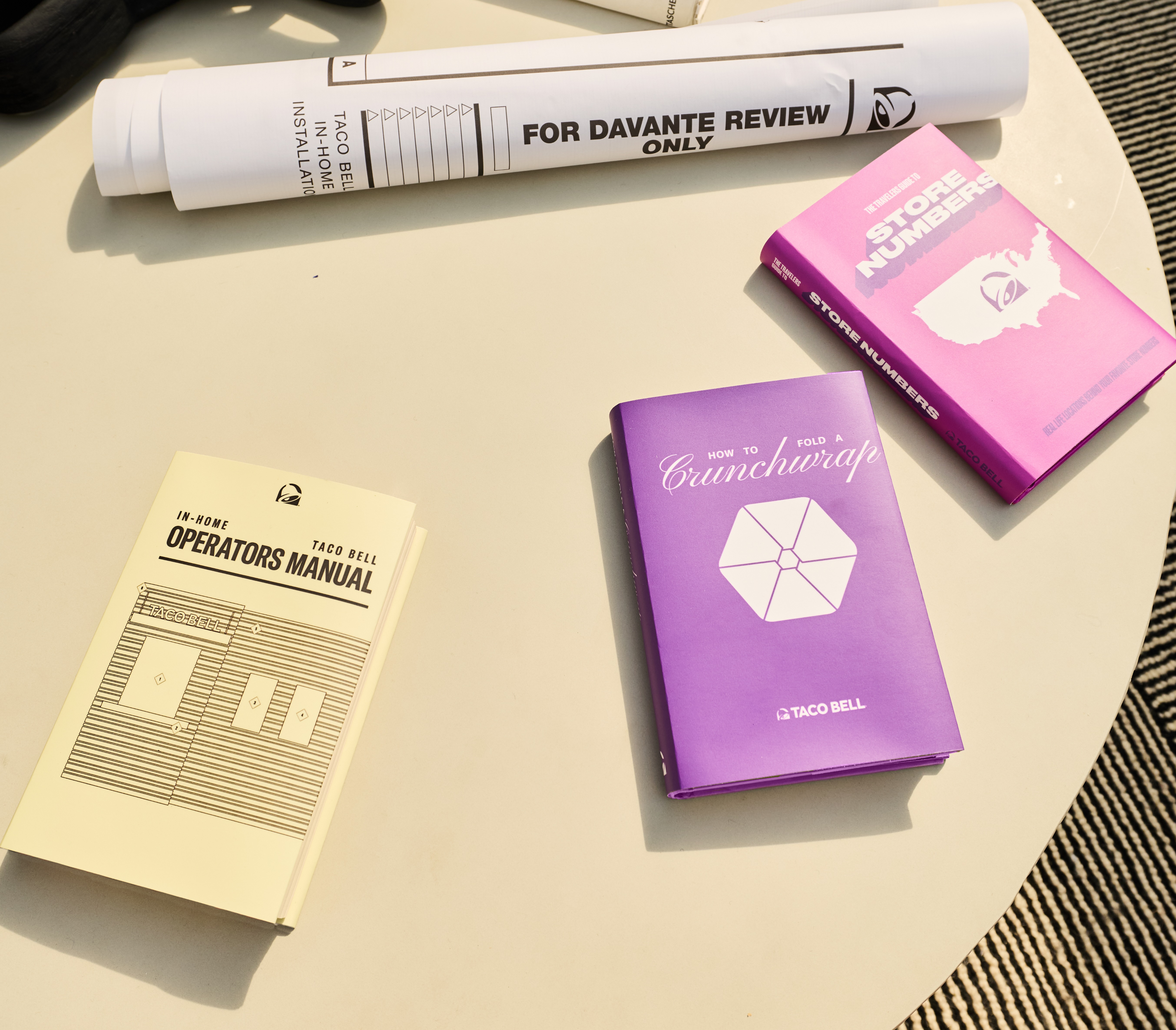 Taco Bell "informational literature" like blueprints, a store operators manual, a book of store numbers and an entire novel about how to fold a crunchwrap