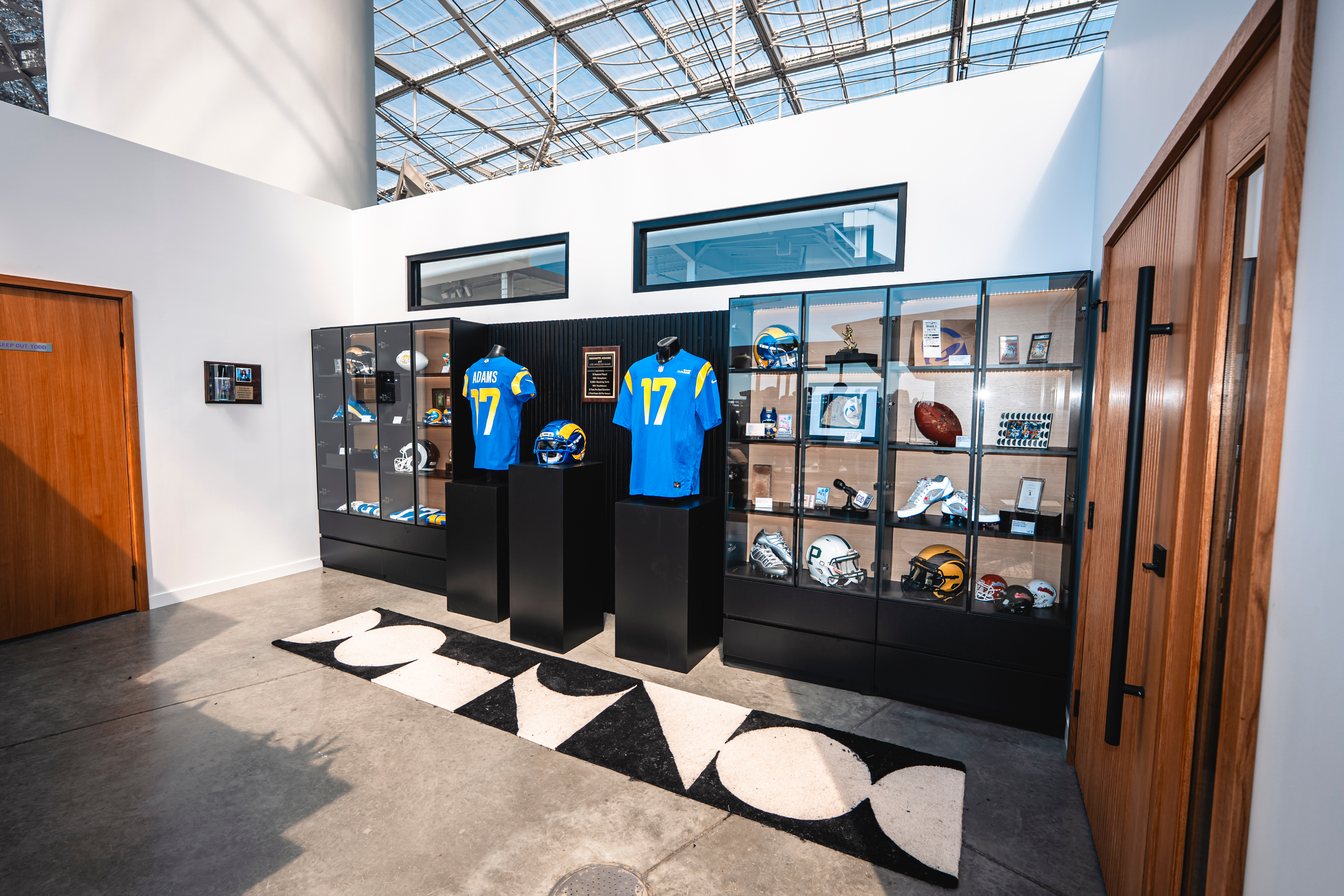 Wall filled with Davante memorabilia like jerseys, helmets, footballs etc...