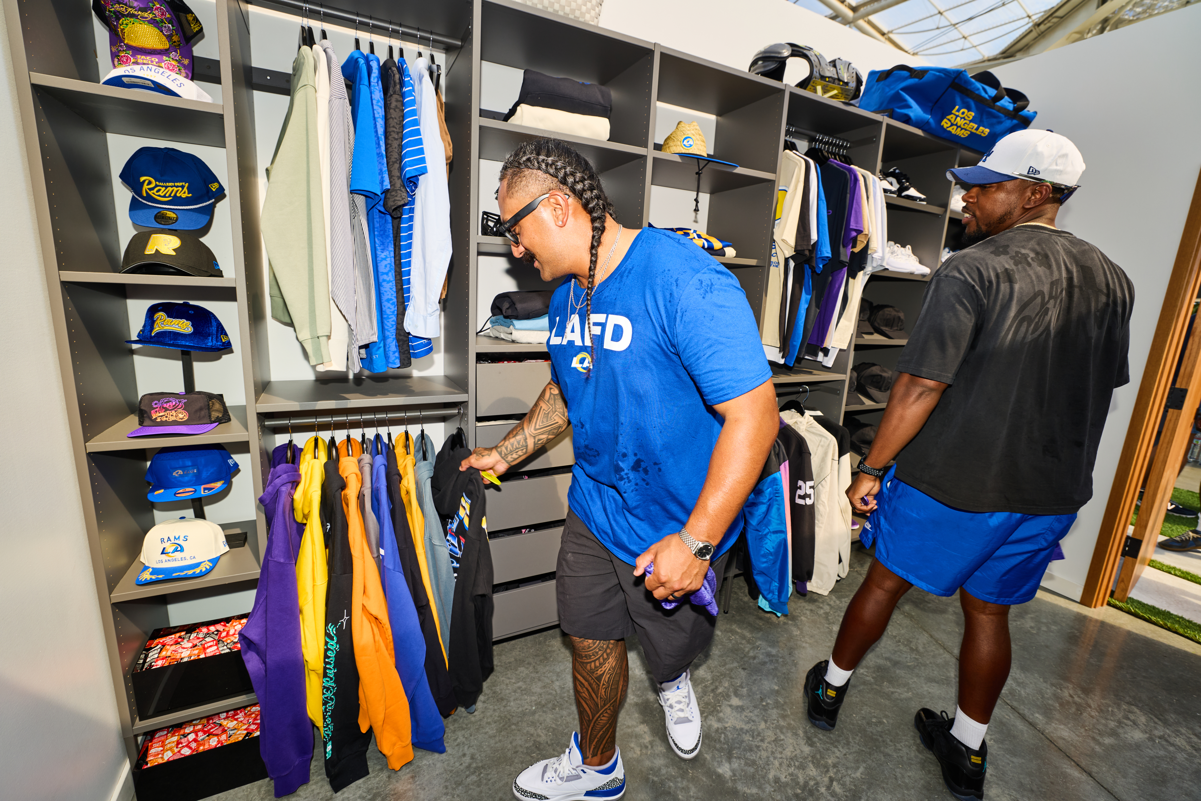 Two people going through Davante's closet