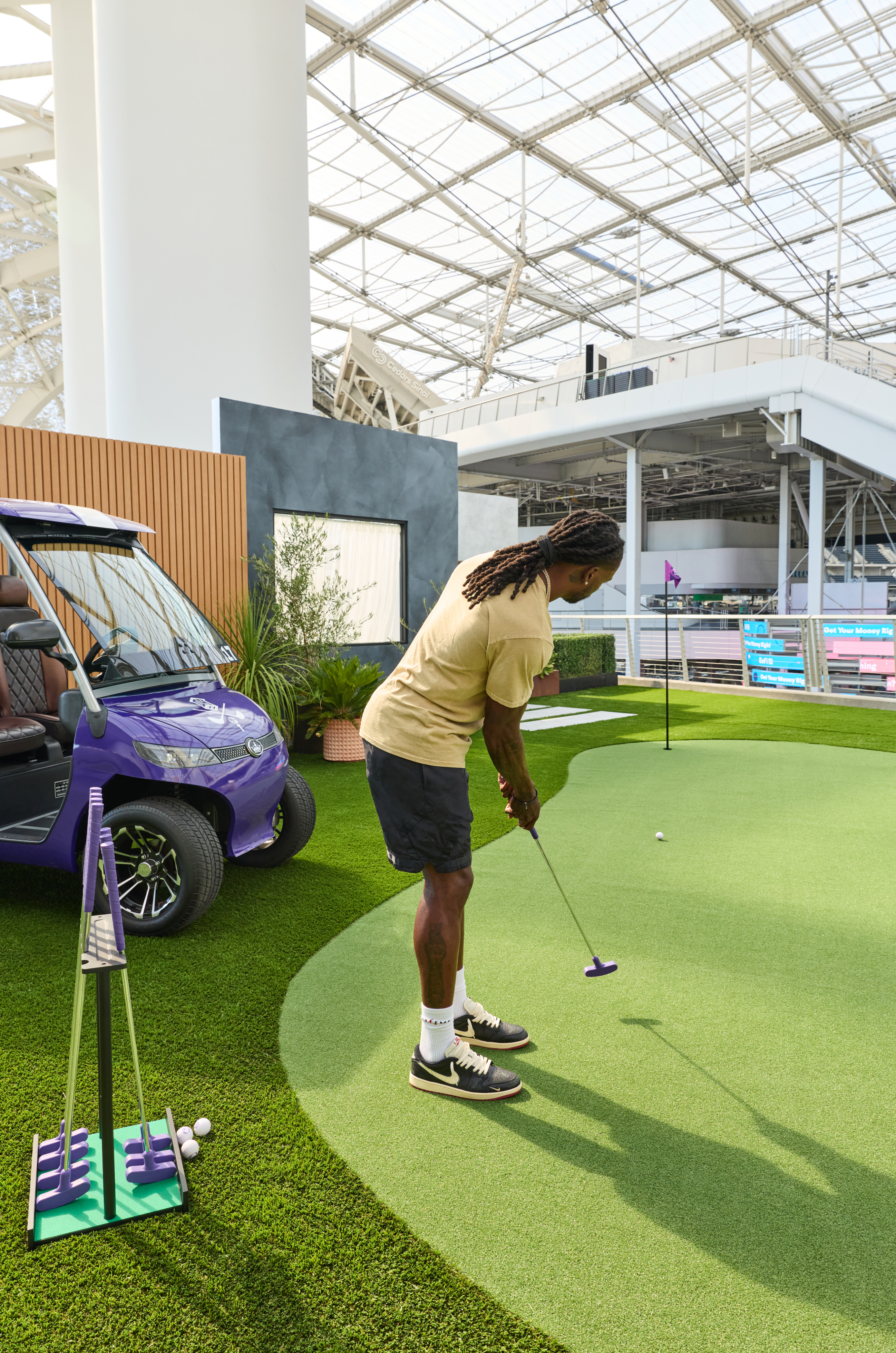 Davante putting on his mini golf course at his Taco Bell house